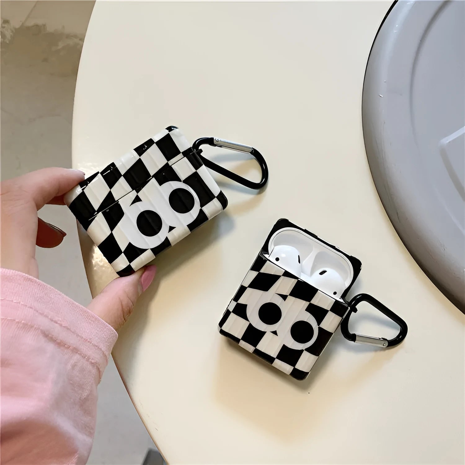 Black and white checkerboard pattern AirPods protective cover with large eye design for Apple AirPods models