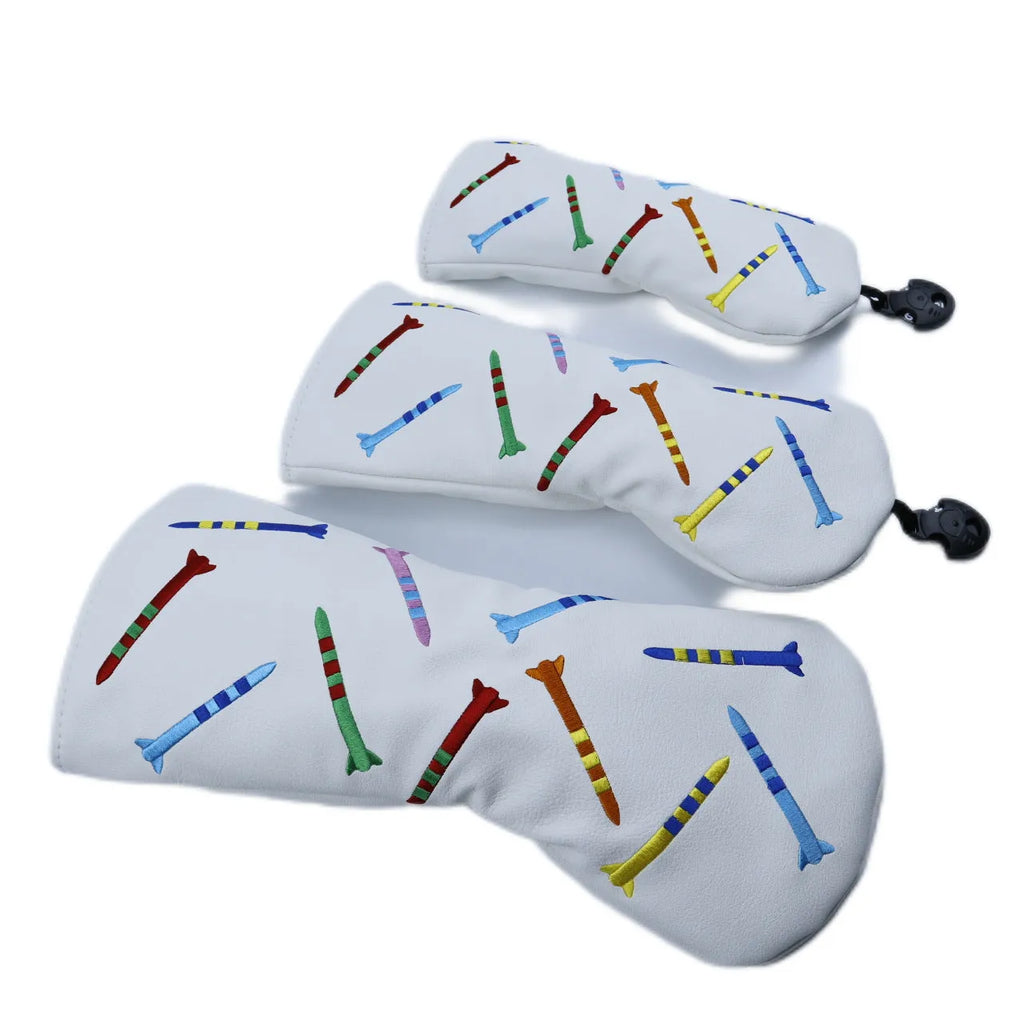 Set of three wooden golf practice clubs in black, showing large, medium, and small sizes on grass.