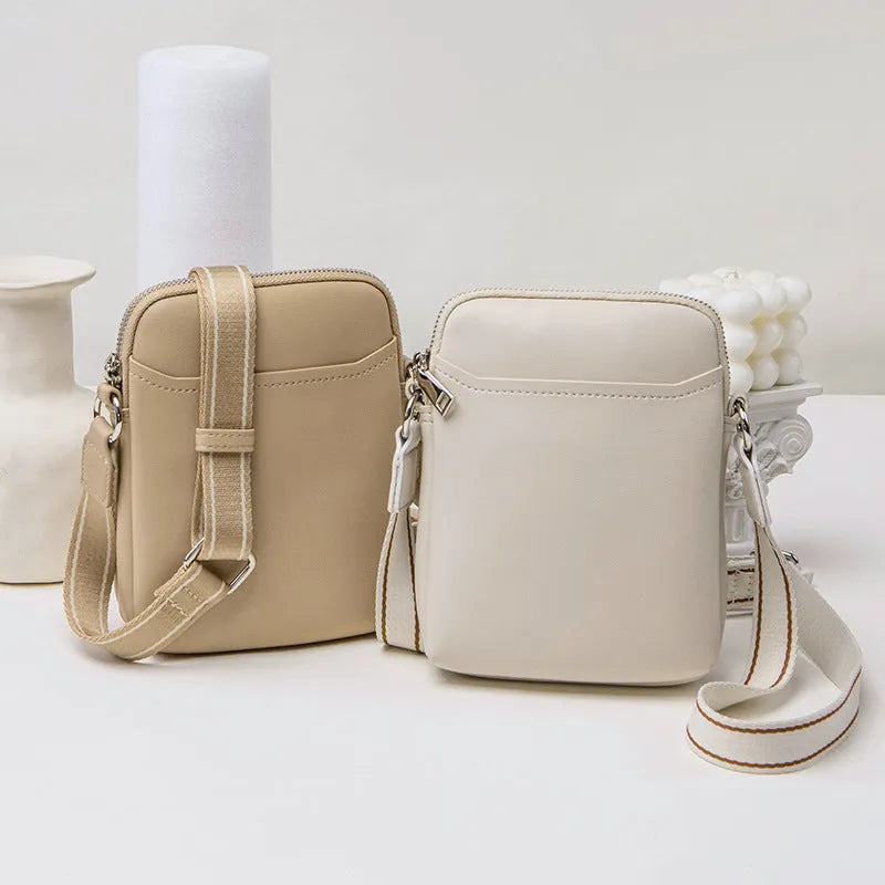 Solid colour crossbody phone bag for women in black, made from PU with an adjustable strap.