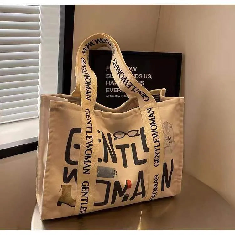 Canvas tote bag with printed design, available in black letters, coloured letters, and pattern style options.