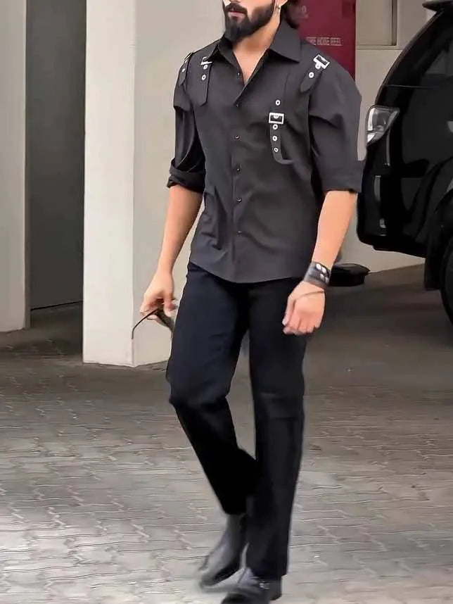 Man wearing a black utility-style button-up shirt with a regular fit.