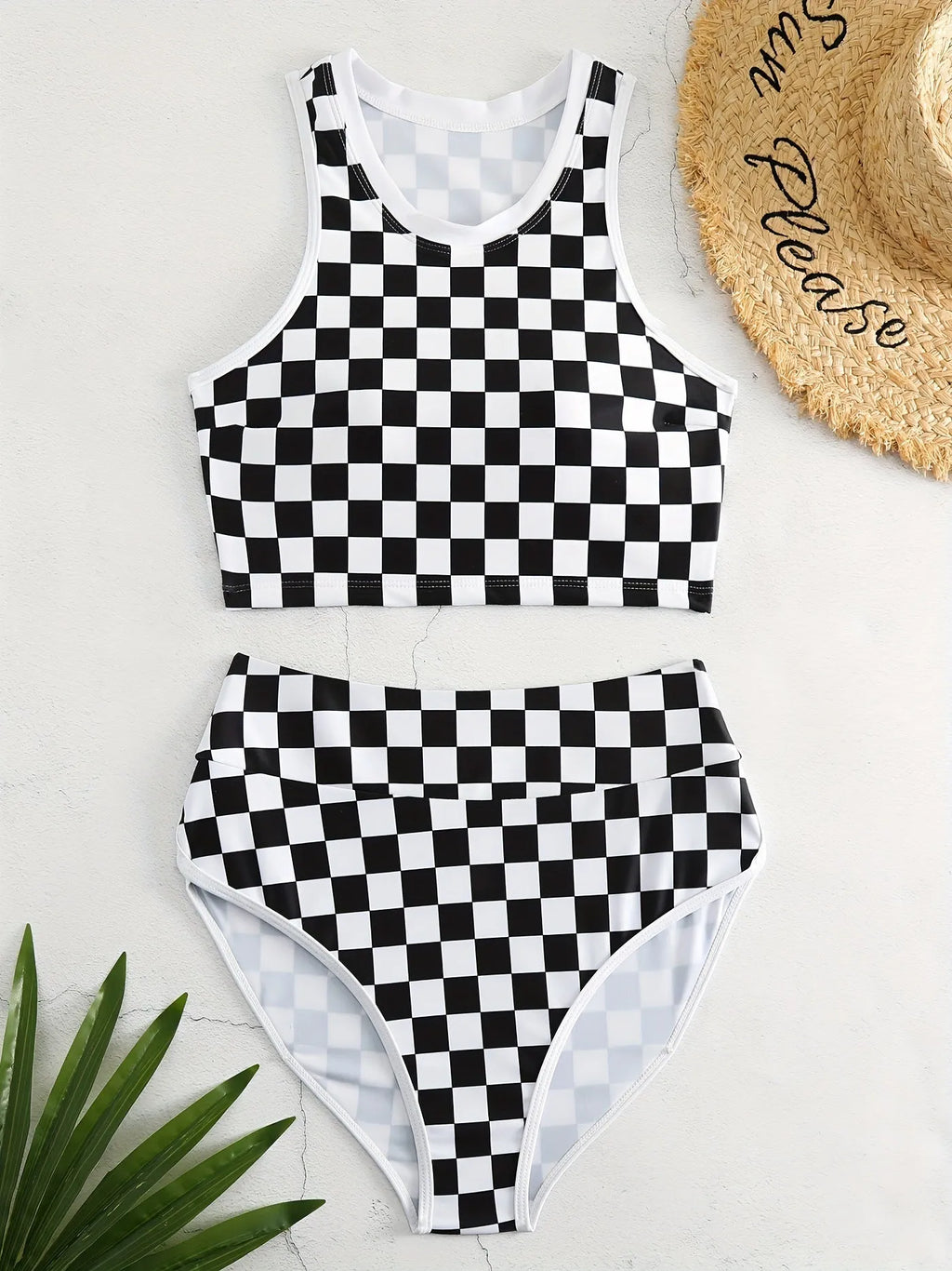 Women's backless racing swimsuit with shoulder suspender strap in black and white chessboard pattern