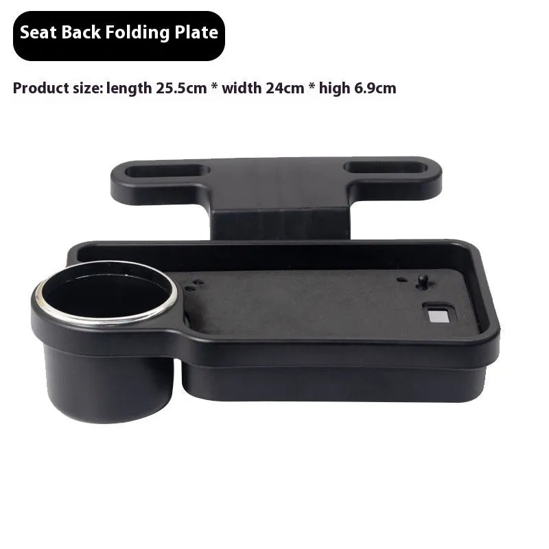 Black foldable car steering wheel laptop stand with a drink cup holder on a table.