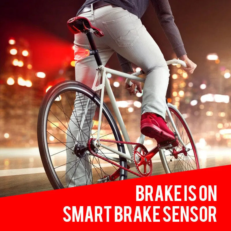 Black aluminium alloy smart bicycle tail light showing USB port and brake-sensing sensor.