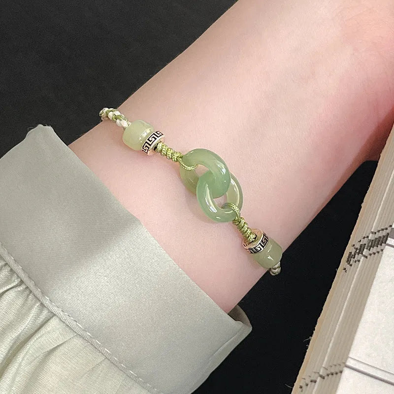 Women's green and copper ethnic-style bracelet with jade buckle weaving and a peace buckle charm.