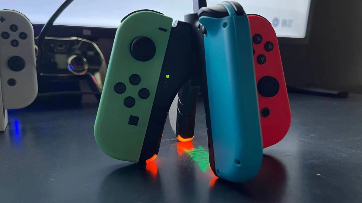 Black ABS four-in-one Joy-Con charger holder with Type-C interface for Switch OLED and Switch rod end.