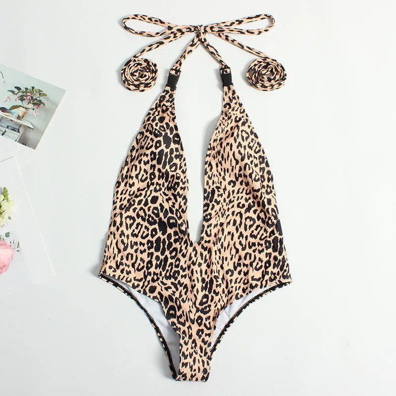 Women's leopard print one-piece swimsuit with buckle bandage and backless design.