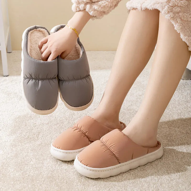 A pair of down cotton indoor slippers with a thick rubber sole and plush lining, shown in a choice of colours.