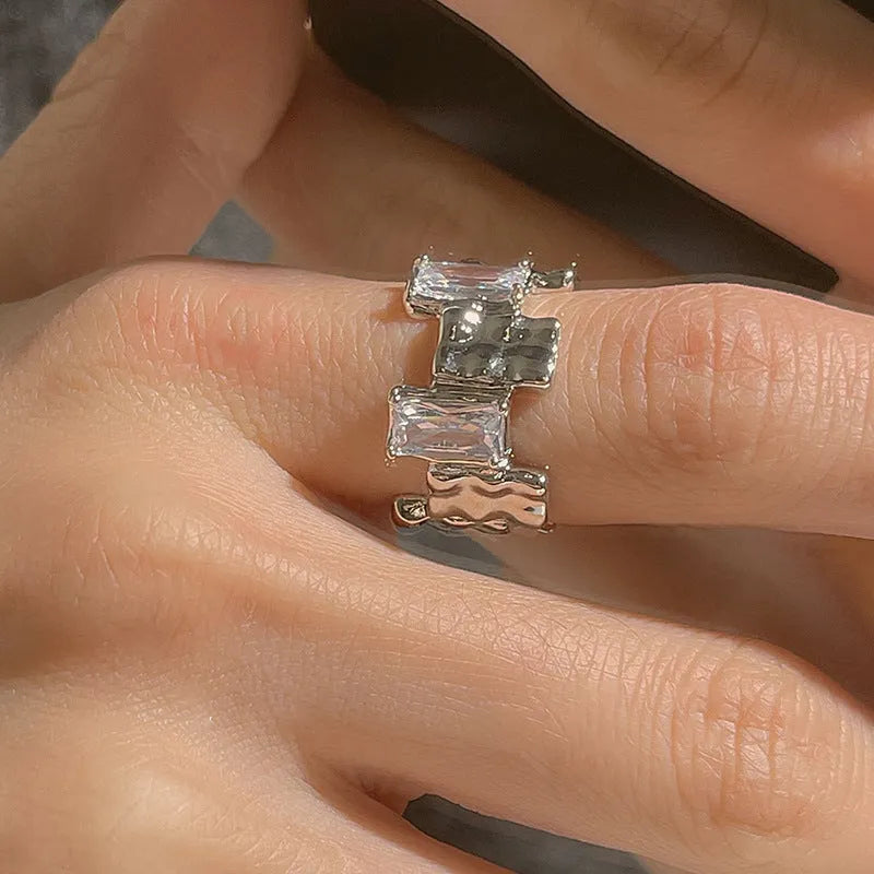 Silver geometric ring with cross zircon design and open gemstone setting