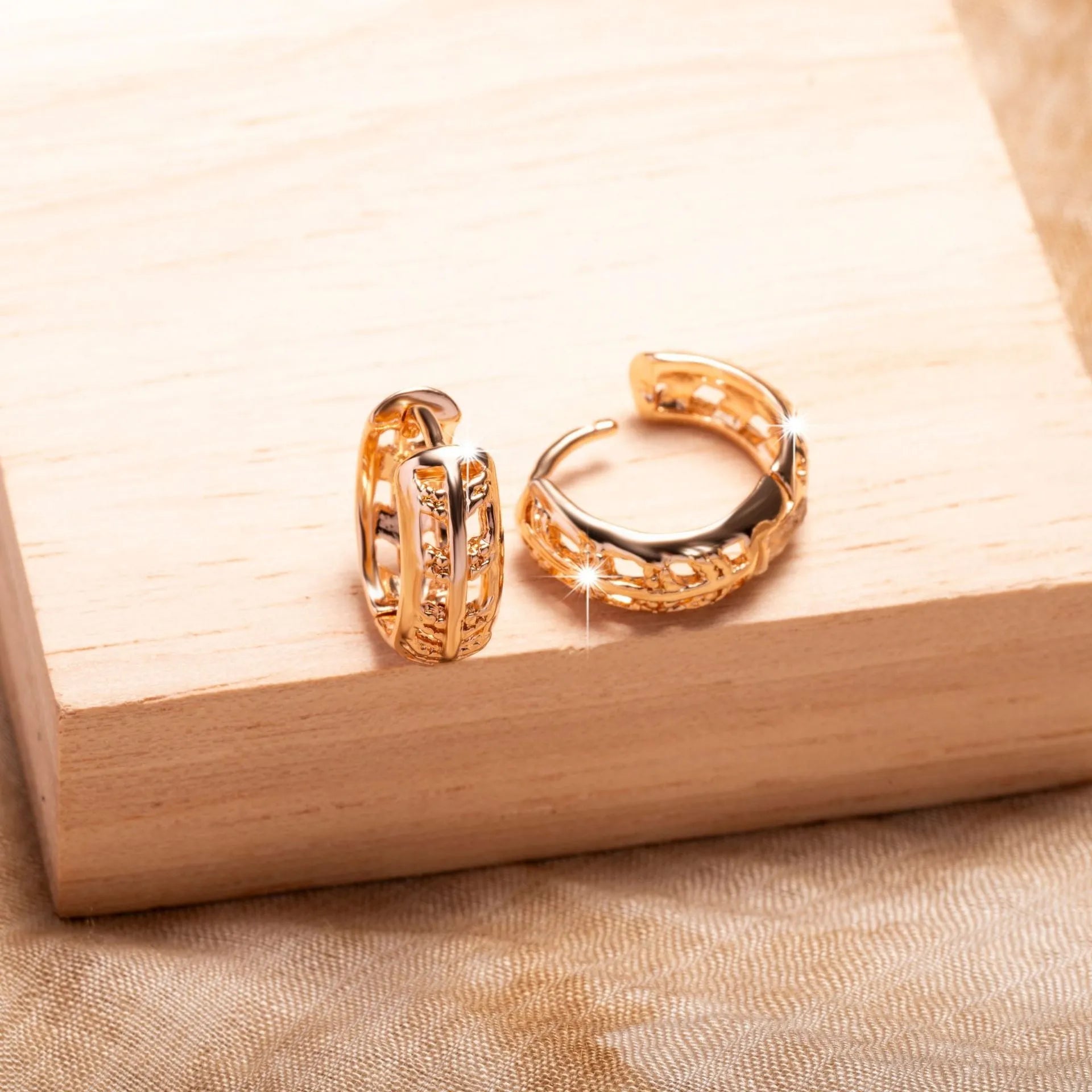 Rose gold plated copper earrings with hollowed-out heart and leaf shapes on a white background.