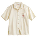 Light apricot men's shirt with bamboo floral pattern and Cuban collar.