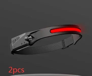 Black silicone USB rechargeable headlamp with wide LED beam and side wave sensor for outdoor use.