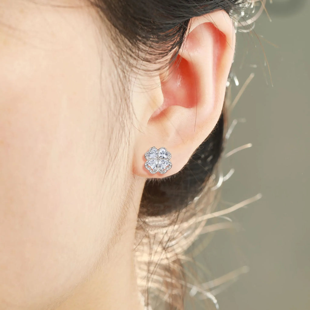 A pair of 925 silver four-leaf clover earrings with zircon stones in a heart-shaped setting.