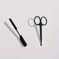 Black pet grooming brush with soft bristles for tear stain removal and comb attachment for dogs and cats