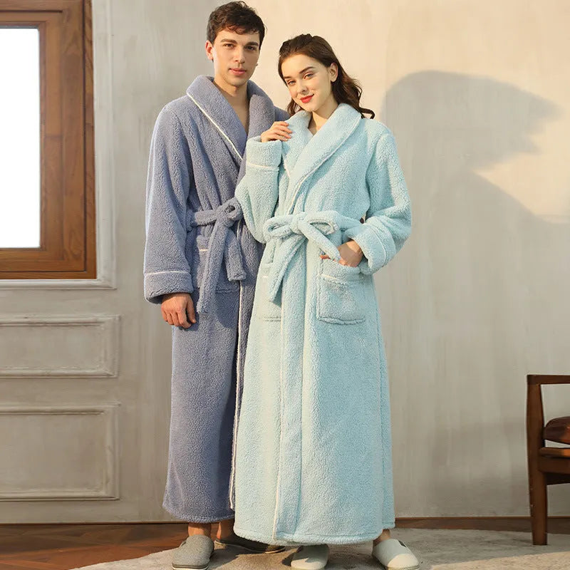 Man and woman wearing matching thick navy blue flannel bathrobes, showcasing the couple's winter loungewear.
