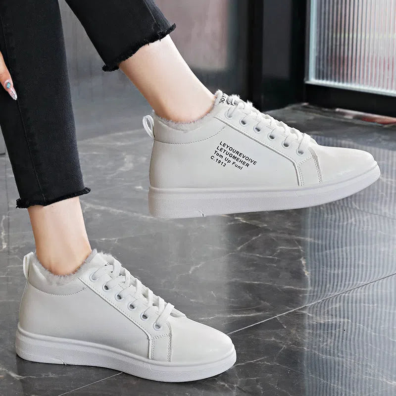 Women's flat sneakers with round toe and front lacing in black, brown, white, and pink