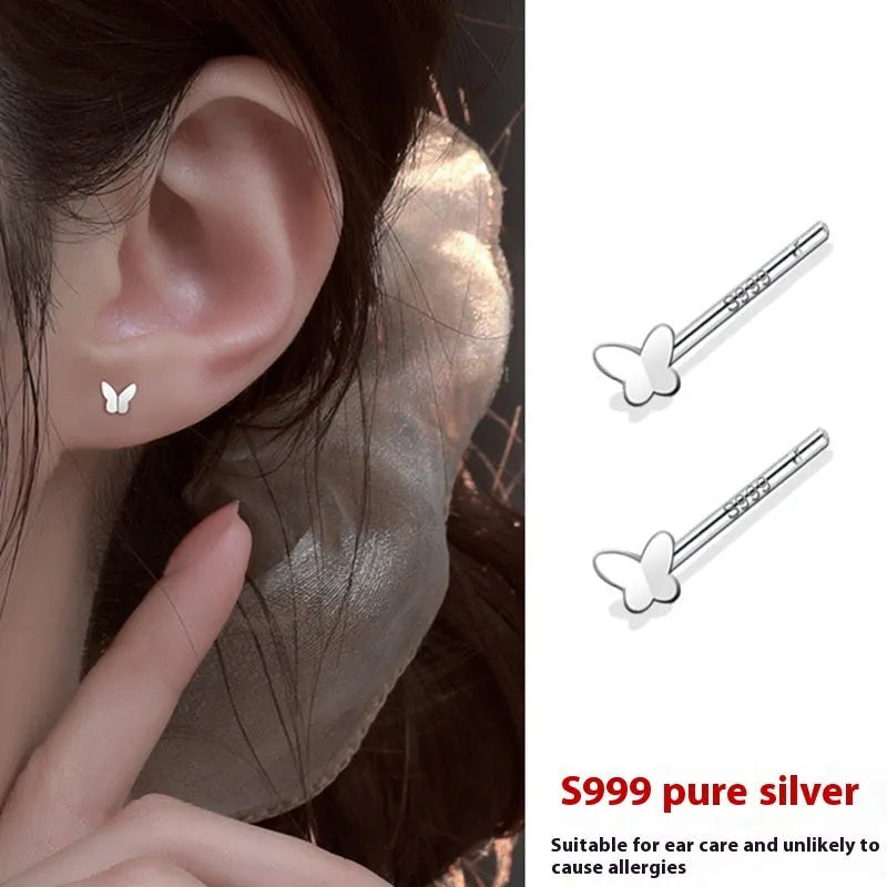999 pure silver anti-blocking ear studs in butterfly shape on white background