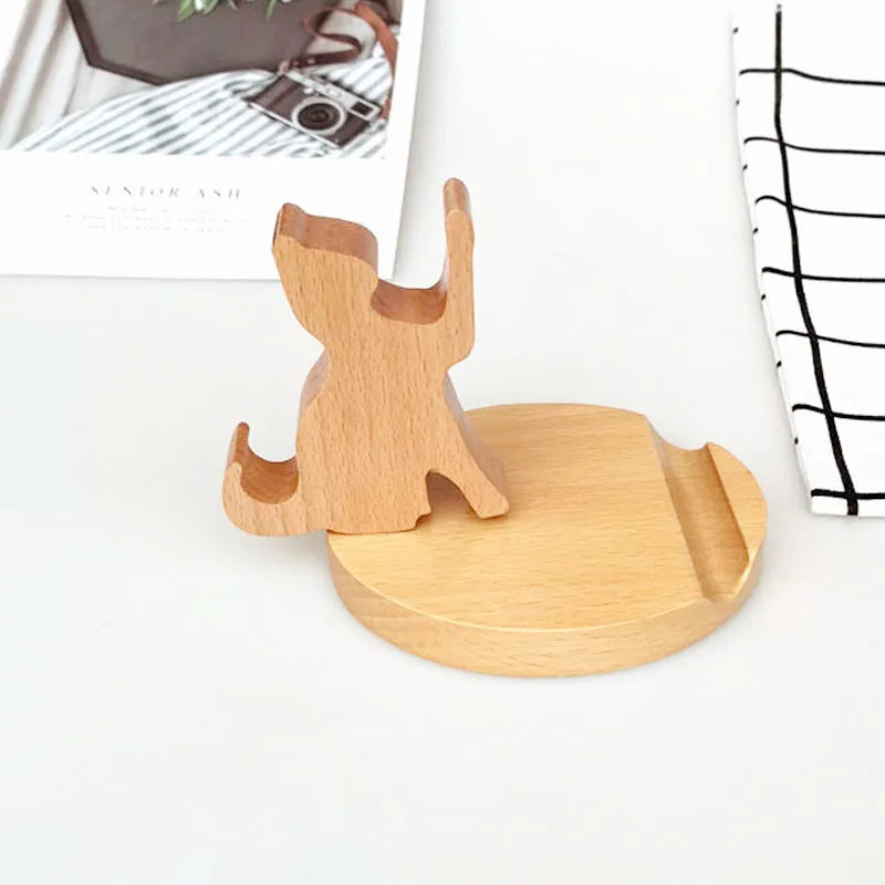A decorative resin mobile phone stand holding a smartphone, shown in an animal design variant.
