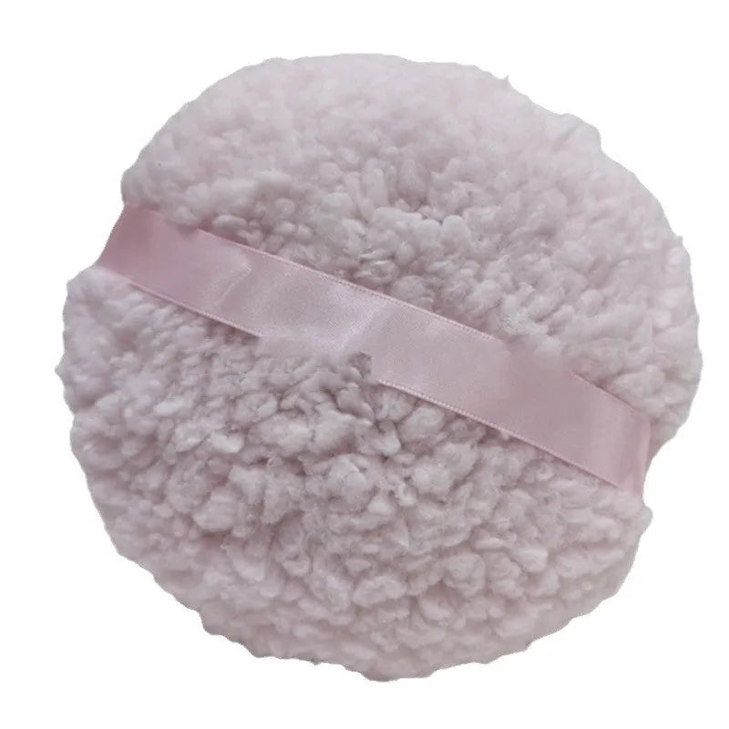 Large rectangular plush makeup powder puff in white on pink background.