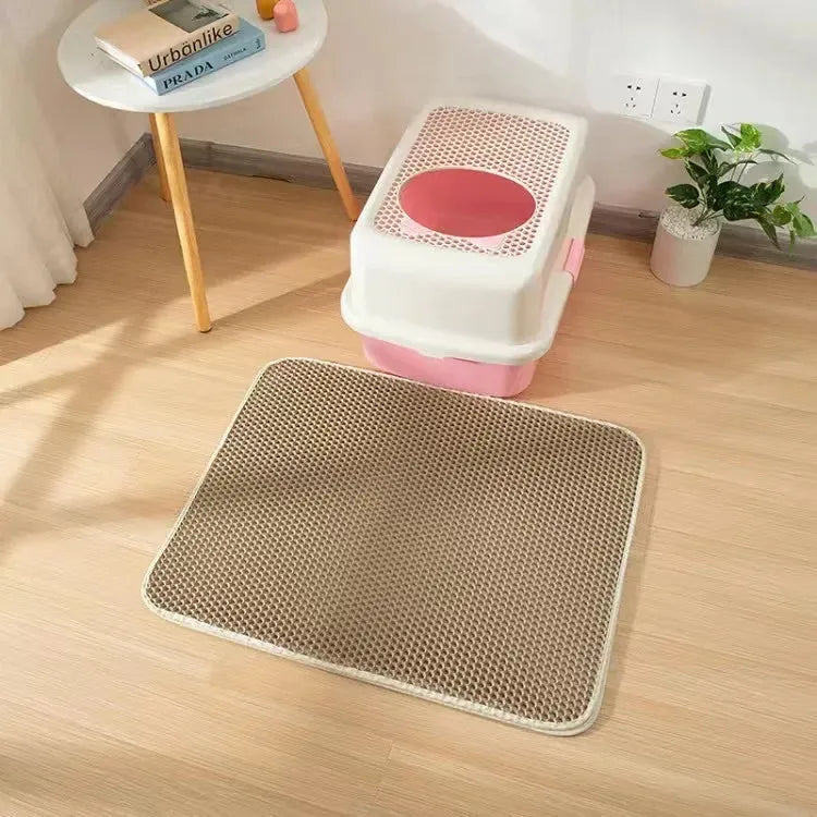 Black EVA foam cat litter pad with honeycomb design beside litter box