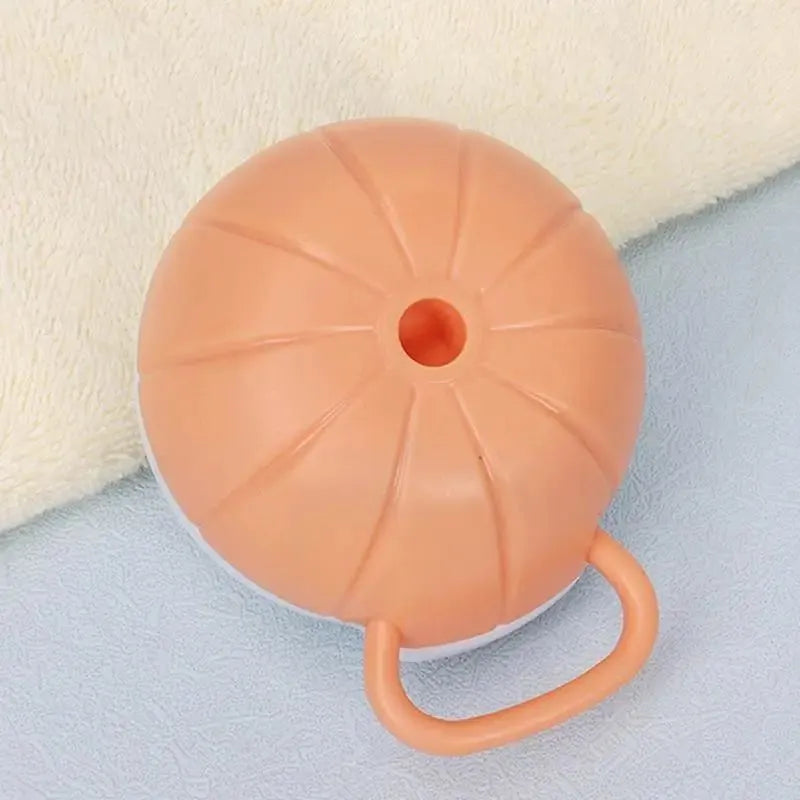 Orange TPR dog bath brush with shampoo dispenser and curved pumpkin grip design