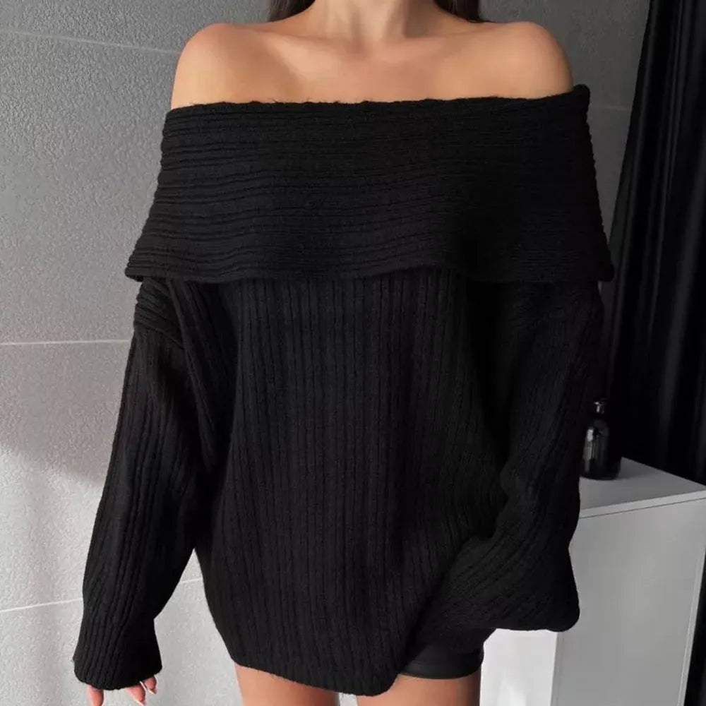 Woman wearing a loose red acrylic pullover sweater with long sleeves.