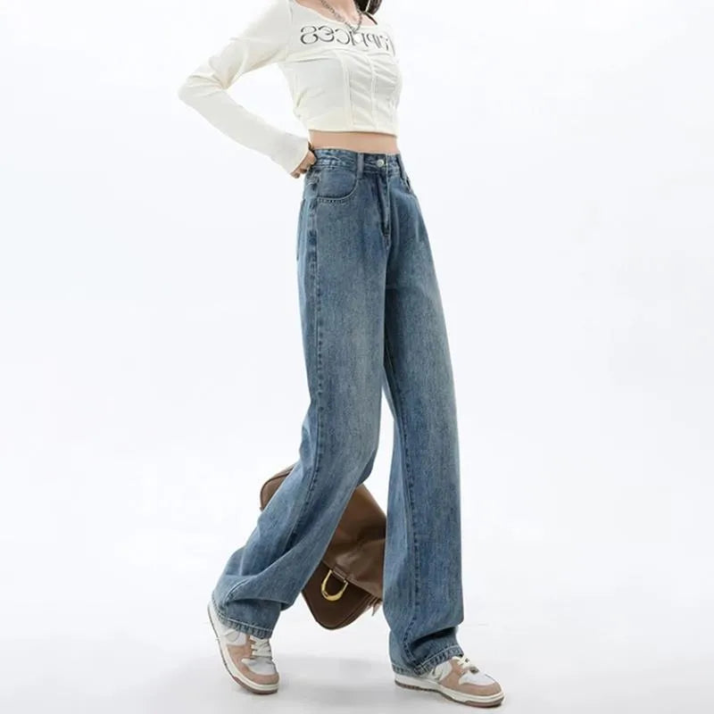 Women's retro blue high-waist wide-leg denim jeans on a hanger, showing the straight leg cut and front pockets.