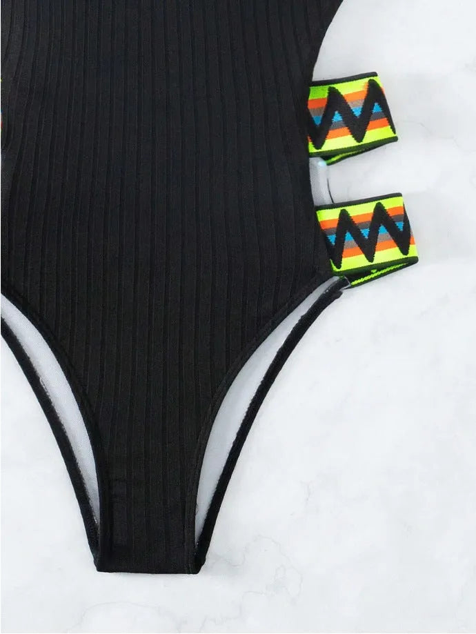 Women's solid colour one-piece swimsuit in black, made from quick-dry polyester fabric.