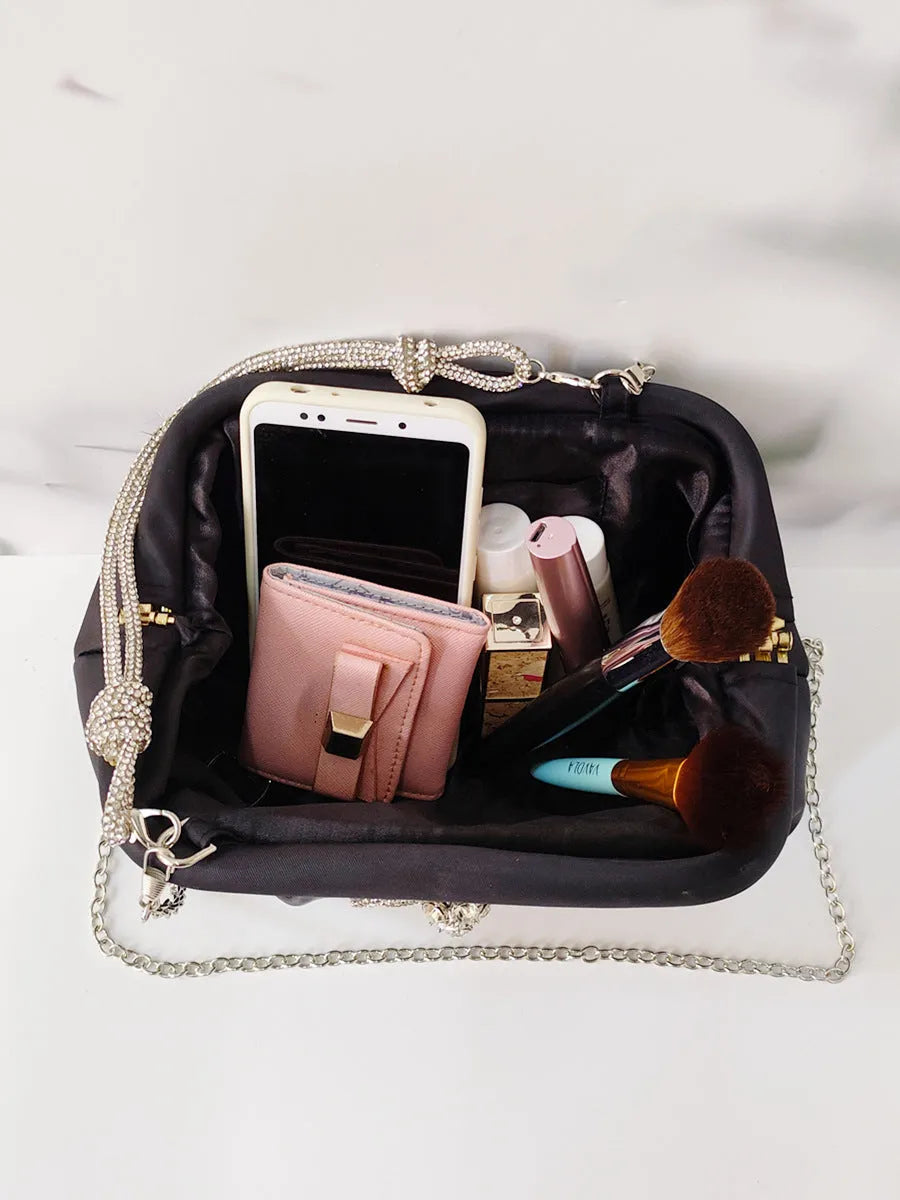 Soft black polyester women's crossbody messenger bag with chain strap and diamond pattern.