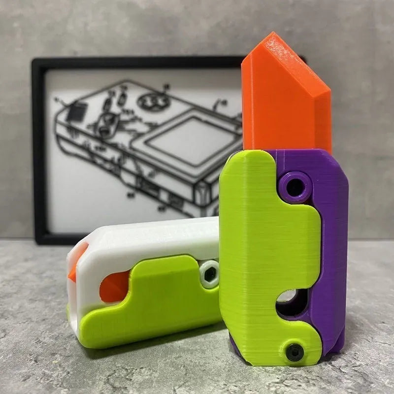 3D printed plastic gravity carrot knife fidget toy in orange, purple, and green colours.