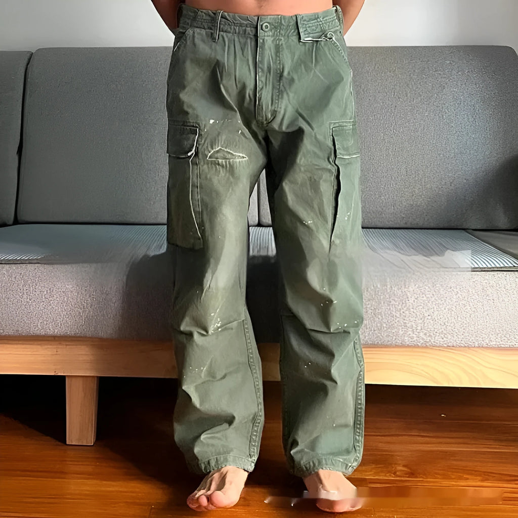 Men's loose fit washed cotton paratrooper pants in Army Green with large pockets, flat lay