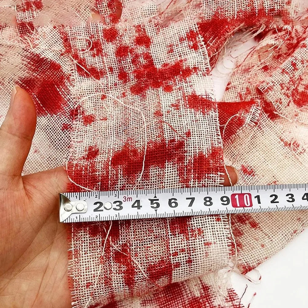 Roll of 8cm wide bloody red Halloween bandage gauze for horror decoration next to a white variant.