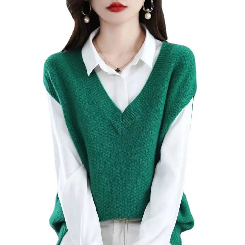 Creamy-white V-neck sleeveless knitted vest with a raised 3D pattern, laid flat.