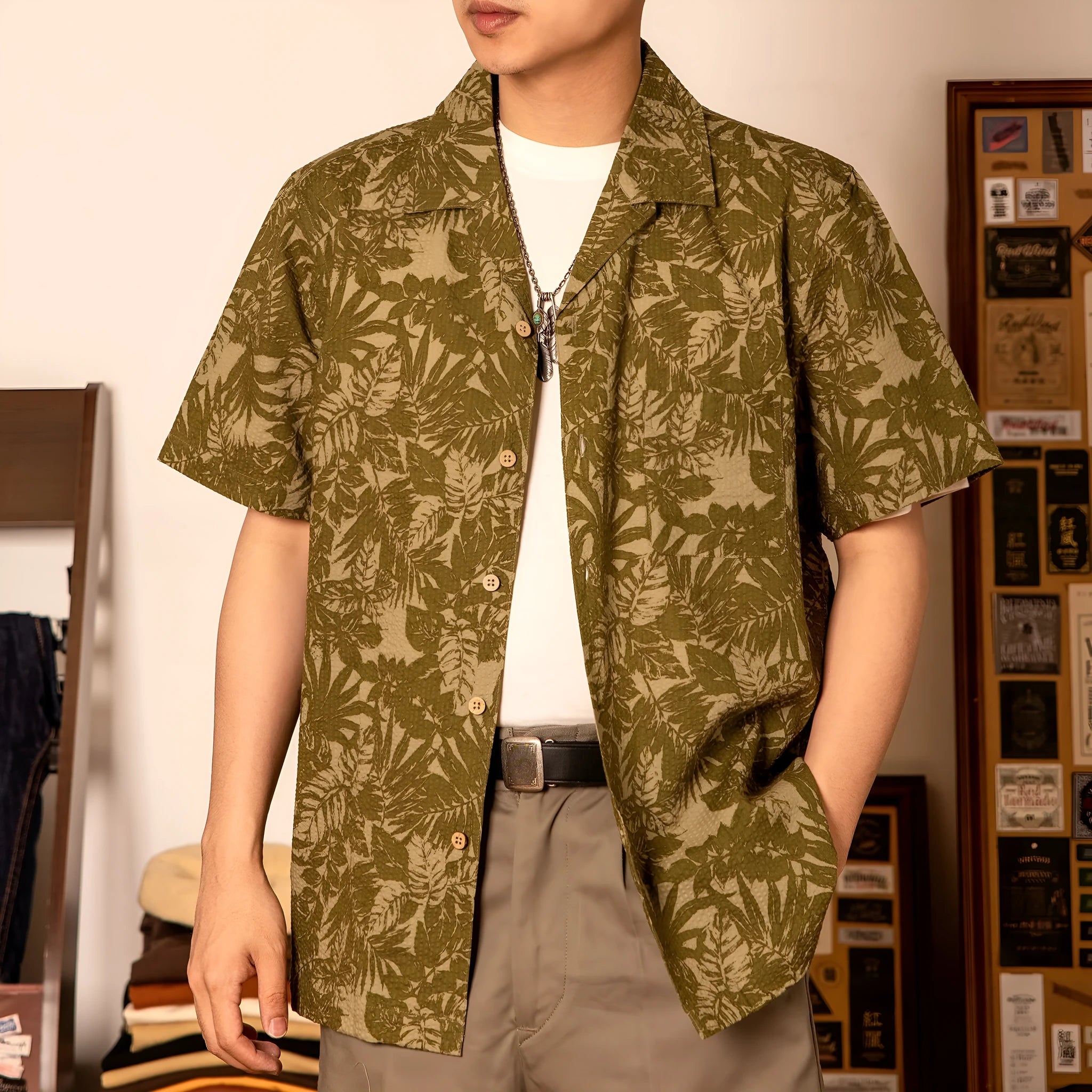 Man wearing a vintage floral print seersucker shirt with a Cuban collar in a loose, casual fit.