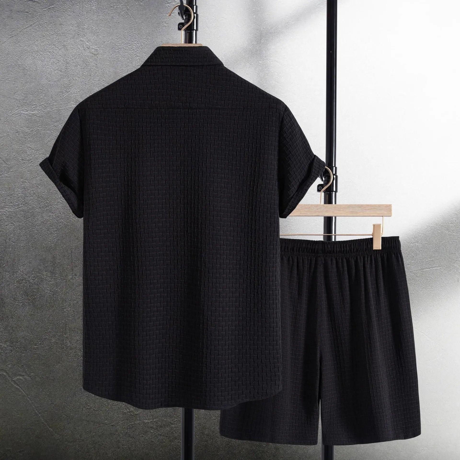 Men's loose fit cotton blend beach shorts suit in black, showing short sleeve shirt and matching shorts.