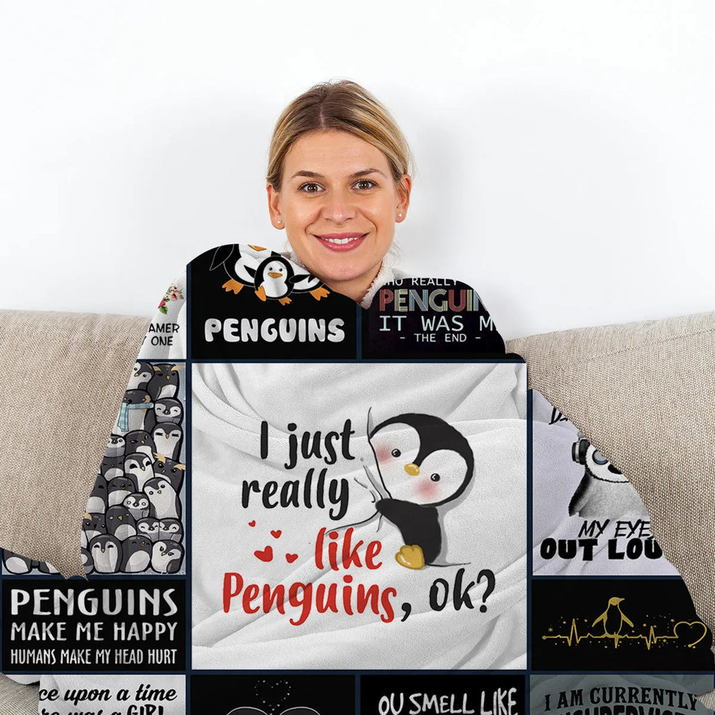 Multicoloured flannel throw blanket with penguin patterns, 130x150cm size on a sofa