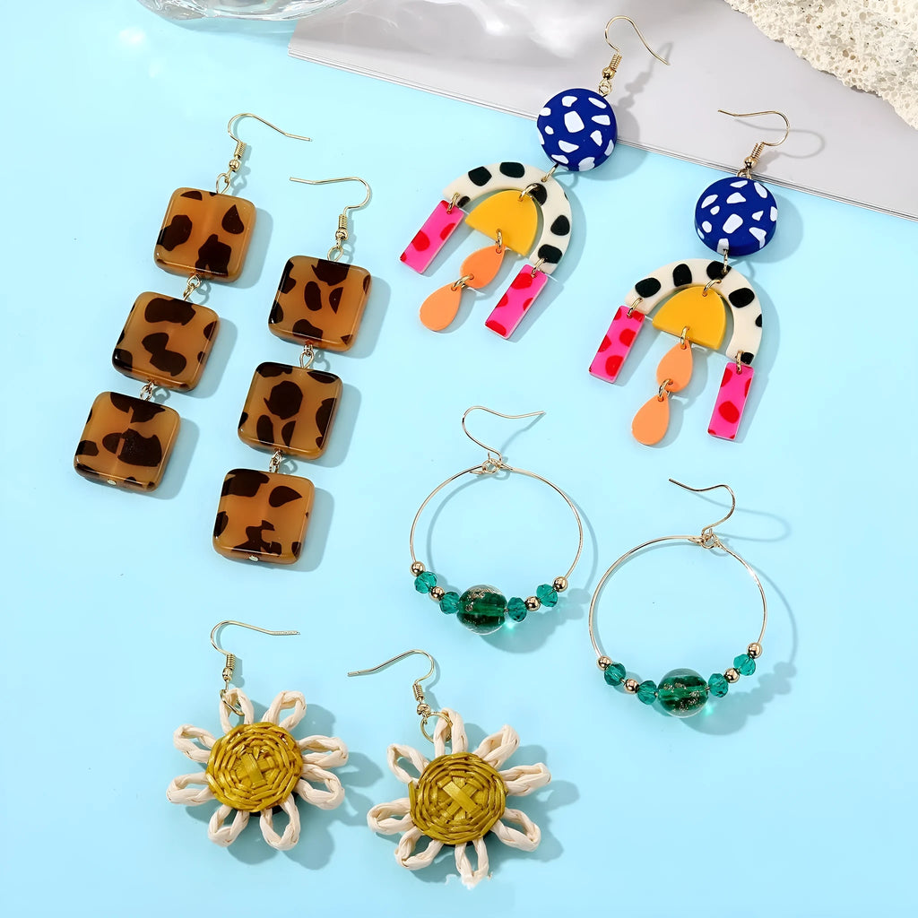 Set of three women's geometric square ear studs with leopard print, sunflower, and coloured glaze bead designs on plastic resin material