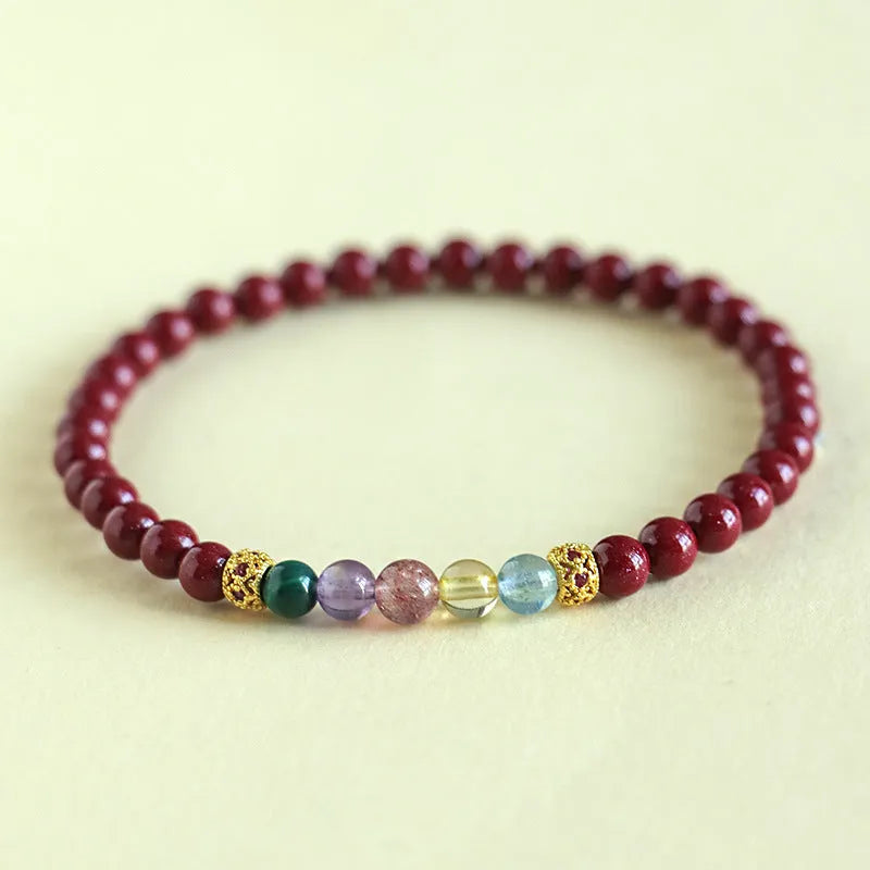 Purple gold cinnabar crystal bead bracelet on wrist showing handcrafted string construction