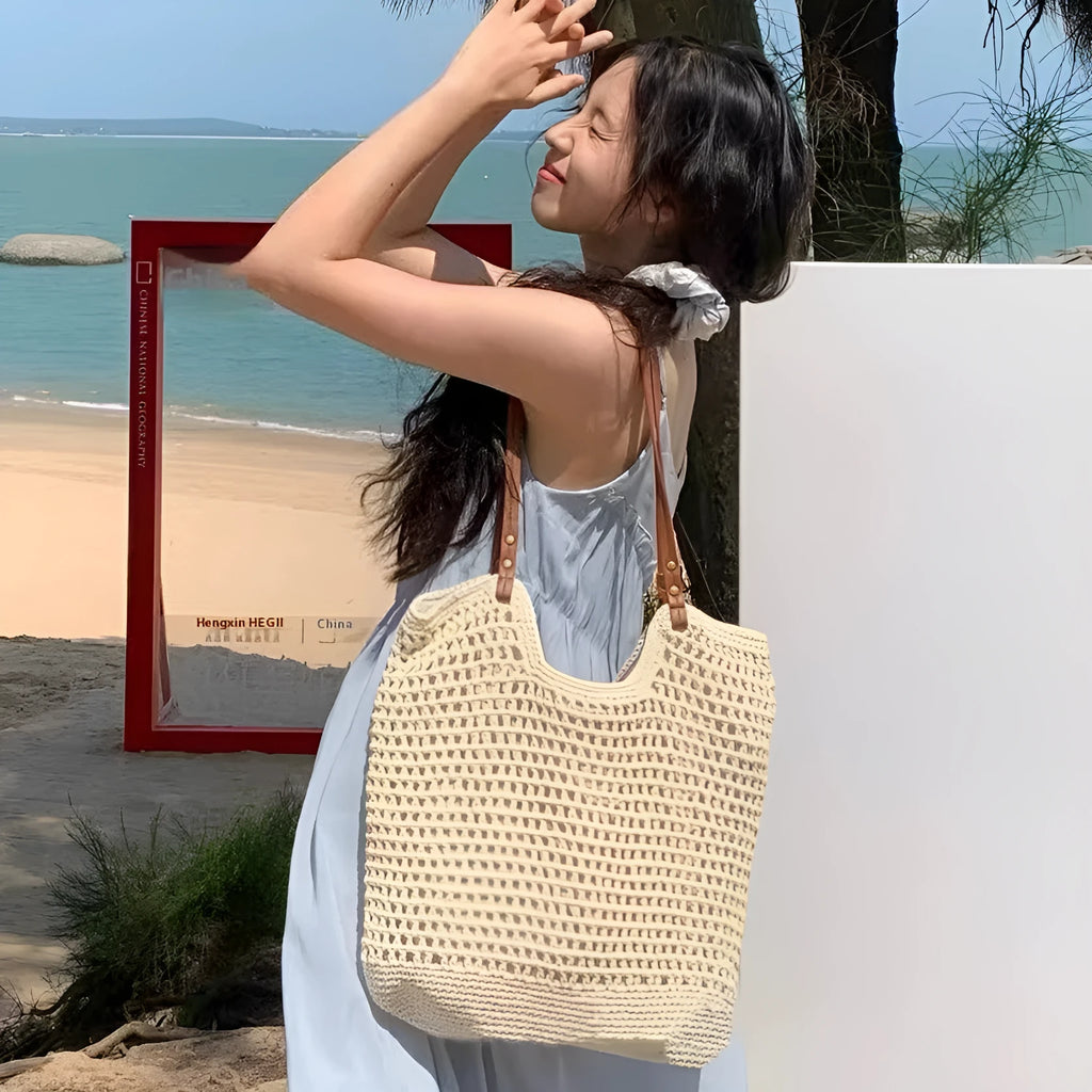 Beige woven cotton linen shoulder bag with a large main compartment.