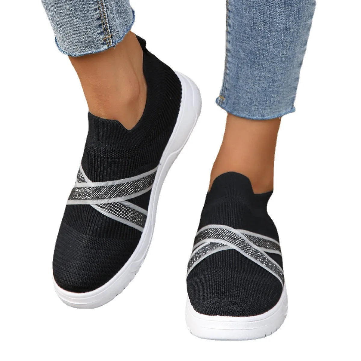 Women's black flyknit mesh outdoor shoes with flat rubber sole and tassel detail.