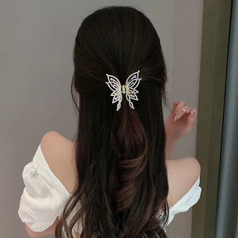 Butterfly-shaped alloy hair clip for women with rhinestone or pearl decoration.
