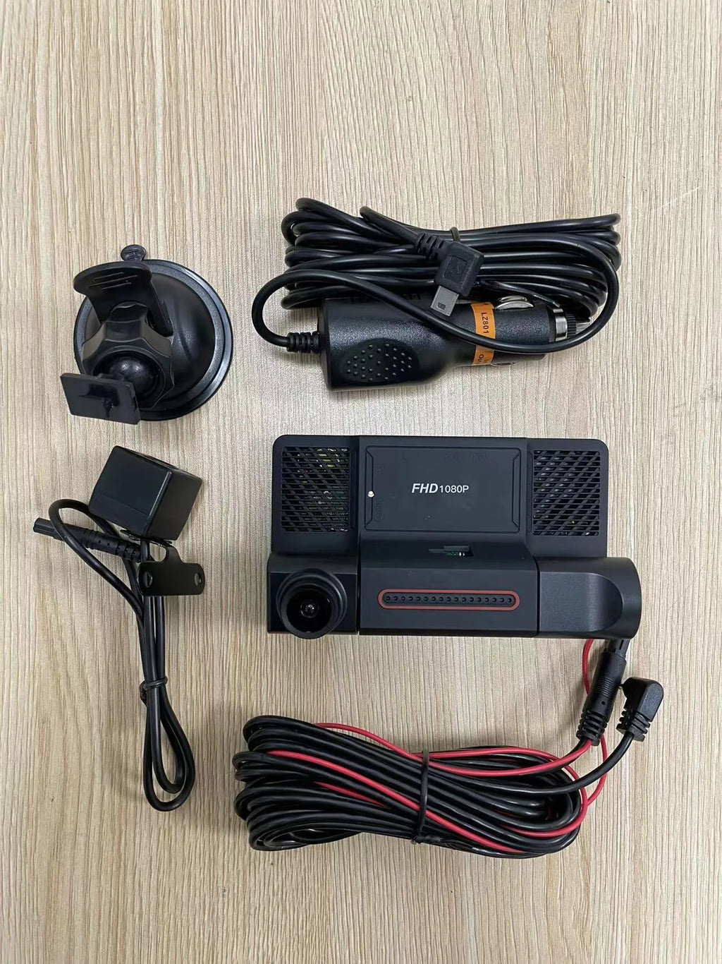 Black three-lens dashcam with 4-inch touchscreen display for front and rear car recording