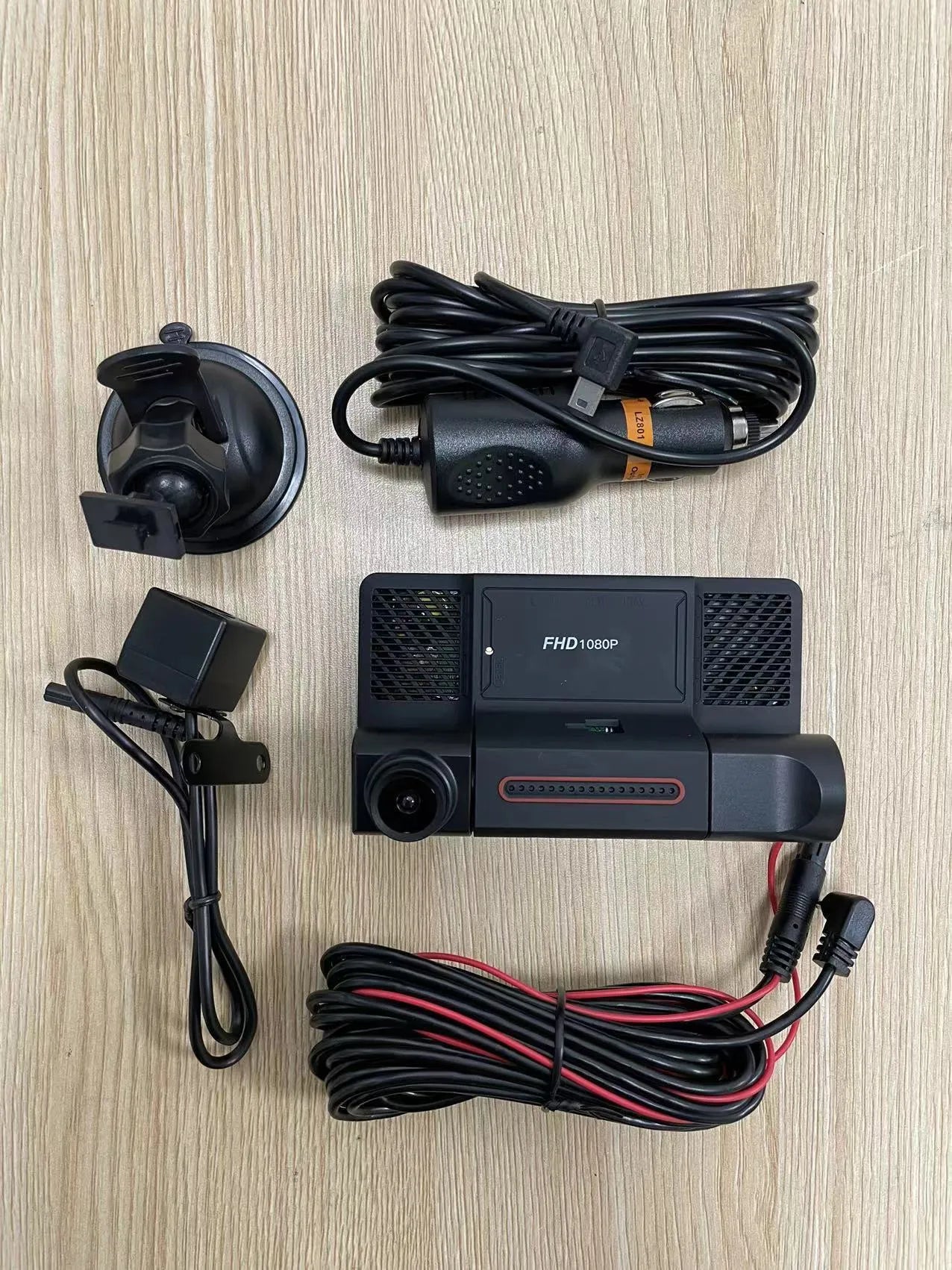 Black three-lens dashcam with 4-inch touchscreen display for front and rear car recording