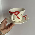 Hand painted ceramic coffee cup and saucer set in Cherry colour, irregular shape, white porcelain, 301-400ml capacity