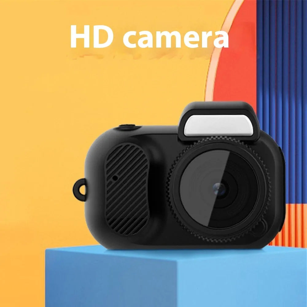 Black retro-style mini digital video camera with small screen shown on a table.