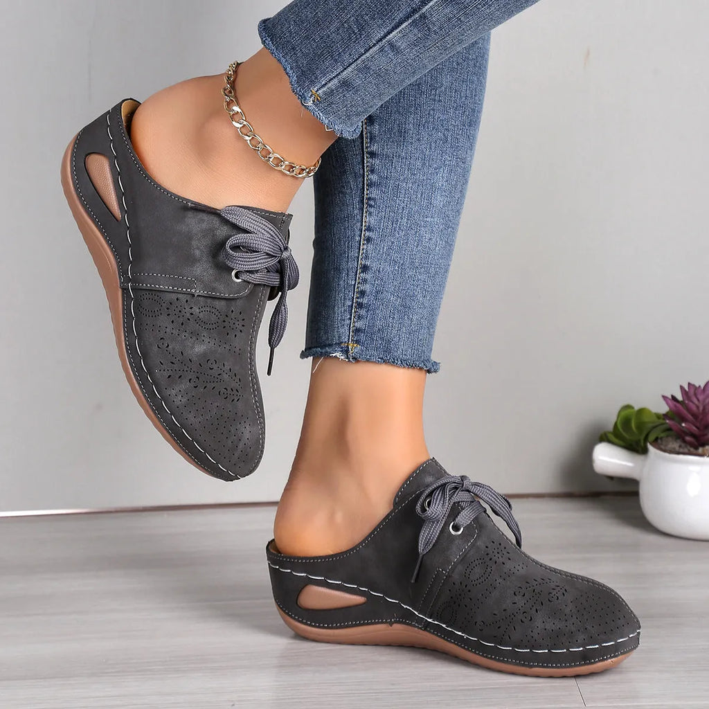 Women's black suede lace-up wedge sandals with a hollow-out design and rubber sole.