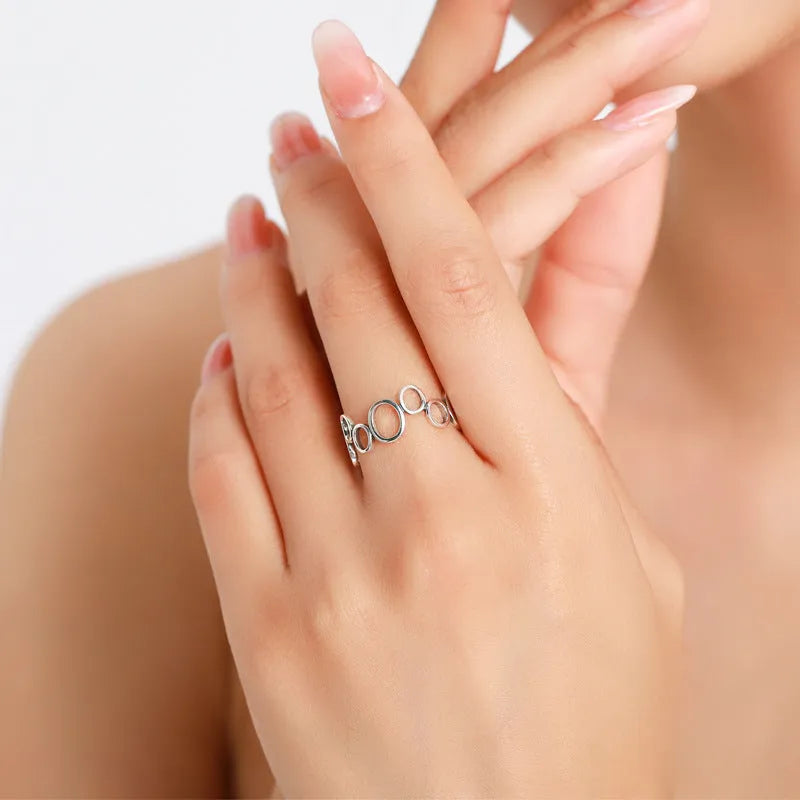 S925 sterling silver geometric circle ring with ellipse motif, women's size US 7 on display