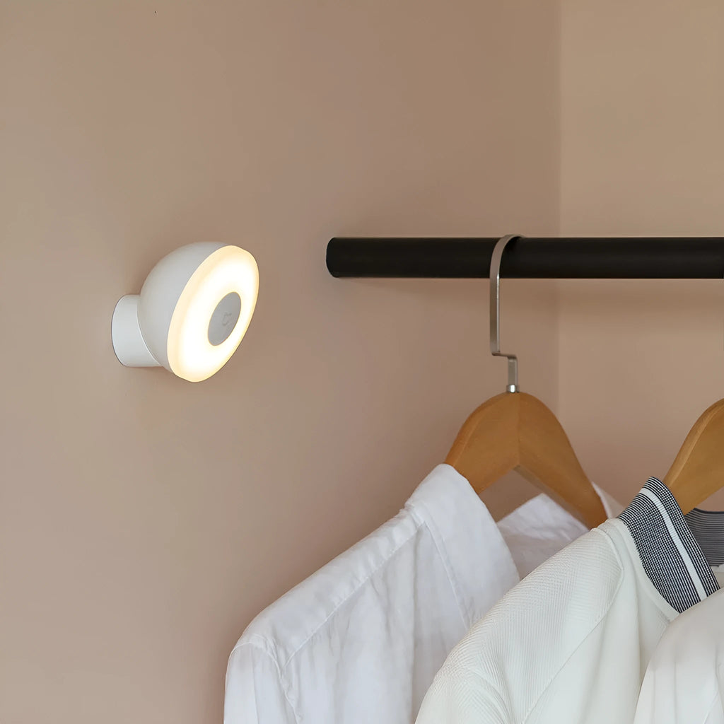 White Mijia Bluetooth bedside table lamp with human body induction on a wooden surface