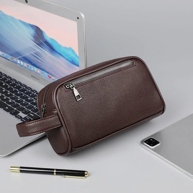 Men's business clutch bag in soft PU leather with large capacity, solid colour finish and zip closure, available in black, dark blue and brown