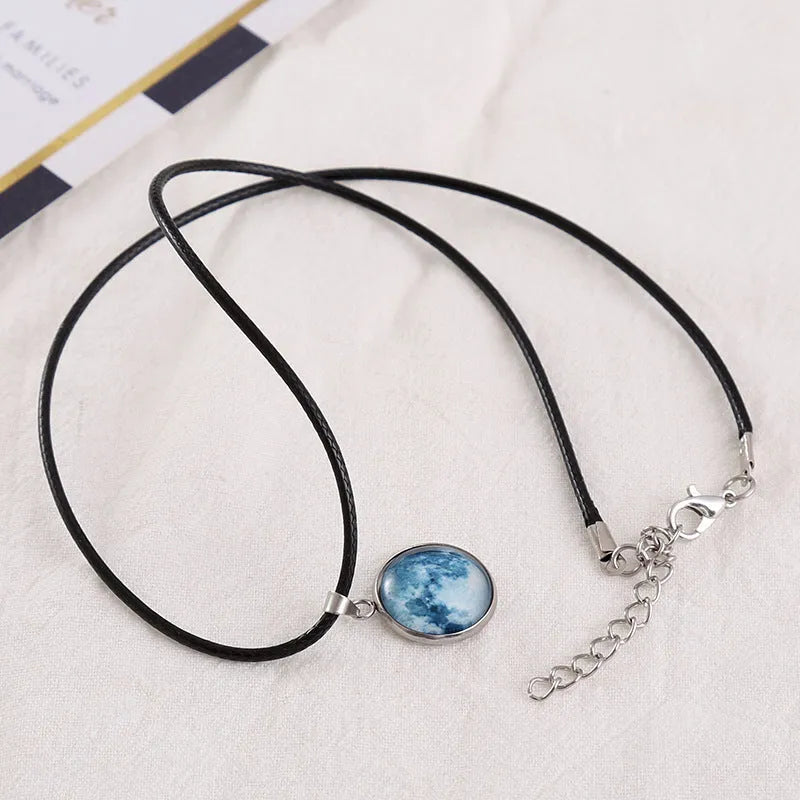 Luminous Christmas moon and starry night sky pendant necklace on a chain with extension.